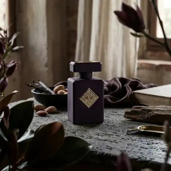 Luxury perfume bottle with a dark matte finish and gold emblem, elegant and sophisticated.