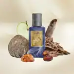 Noble 1942 Shamal fragrance bottle with natural elements including a coconut, amber stones, and wood.