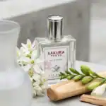 Sakura Tokyo fragrance bottle with white flowers and wooden accents.