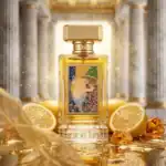 Aragos perfume bottle with artistic label and gold cap, surrounded by lemon slices and amber stones.