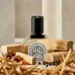 TAMDAO fragrance bottle with black cap on wooden display.