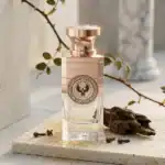 Electimuss perfume bottle with a rose gold cap and intricate logo design.