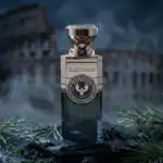 Electimuss perfume bottle with a silver cap and intricate emblem, set against a dramatic background.
