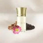 Fleur de Sable perfume bottle with pink flower and black peppercorns, luxury fragrance from Beautino.