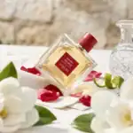 Guerlain Habit Rouge perfume bottle with red cap, elegant and luxurious fragrance.