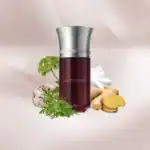 Île Pourpre fragrance bottle with botanical elements and ginger root.