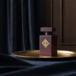 Alwa luxury perfume bottle with gold emblem.