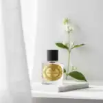 Nishane Climat Collection fragrance bottle with black cap on a white surface.