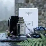 The Different Company Sublim 2 Balances fragrance bottle with packaging and blueberries.