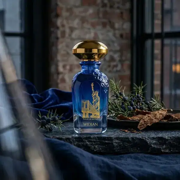 Widian New York Extrait de Parfum - Elegant blue glass bottle with gold cap.