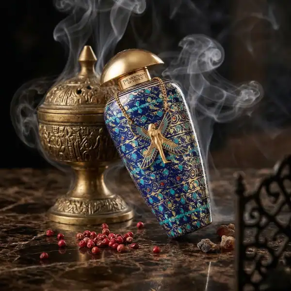 Alwa perfume bottle with intricate blue and gold design, luxury fragrance.