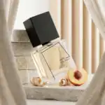 Filippo Sorcinelli Rosa Nigra perfume bottle with peach and wood shavings, elegant display.