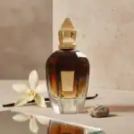 X.A. luxury perfume bottle with a sleek design and warm amber tones, perfect for a sophisticated sce.