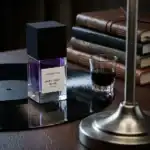 BohoBoco Dark Vinyl Musk perfume bottle with a glass of dark beverage on a vintage record player.
