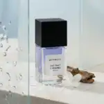 Bohoboco Sea Salt Caramel fragrance bottle with wood and flower accents.