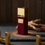 Gratti Privé Florian fragrance bottle with elegant gold cap and deep red textured finish.
