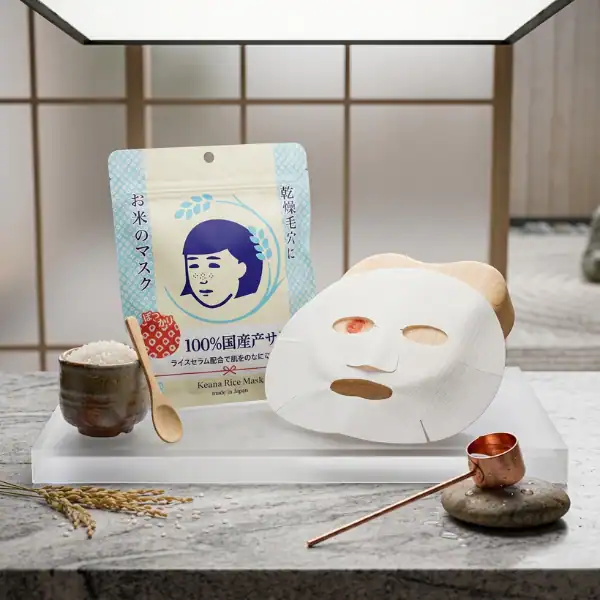 Rice face mask in a spa setting with wooden spoon and copper cup.