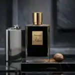 Kilian Intoxicated fragrance bottle with gold cap and black label.
