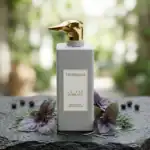 Trussardi Le Vie Di Milano perfume bottle with a gold dog-shaped cap, set against a natural backgrou.