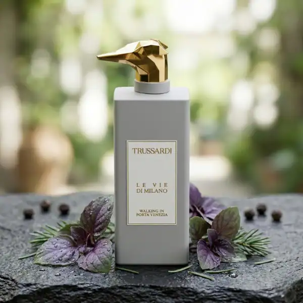 Trussardi Le Vie Di Milano perfume bottle with a gold dog-shaped cap, set against a natural backgrou.