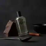 Ako Dark fragrance bottle with a chocolate piece and cinnamon stick.