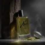 Akro Infuse fragrance bottle with black cap, placed against a textured wooden background.