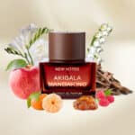 Apple, mandarin, raspberries, jasmine, and musk surrounding a luxury perfume bottle on a neutral background.