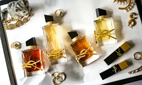 Elegant Yves Saint Laurent perfume collection with high-end accessories and jewelry.