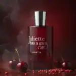 Juliette Has a Gun Cherry fragrance bottle with cherries and red peppercorns.
