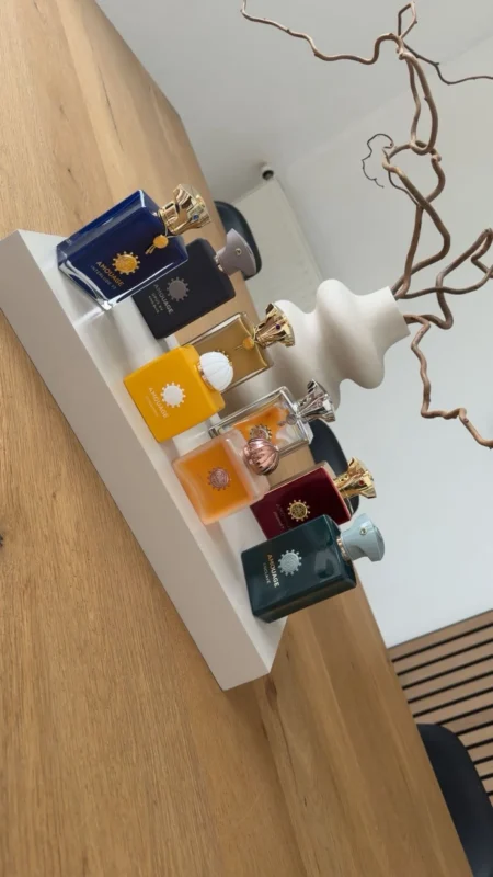 Alva. Luxury perfume bottles and skincare products displayed on a white shelf.