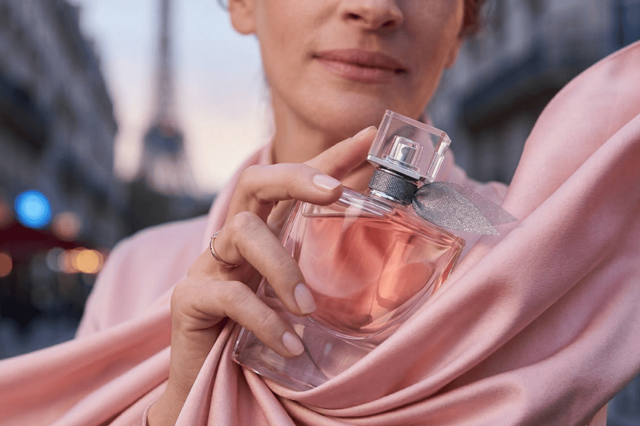 Alwa luxury perfume bottle with a pink hue, elegant design, and crystal cap.