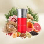 Ame Du Coeur fragrance bottle with natural ingredients, surrounded by botanicals and fruits.
