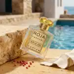 Roja Parfums Isola Sol fragrance bottle with yellow gemstone cap.