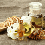 Alwa luxury perfume collection with dried citrus slices, cinnamon sticks, and essential oils.