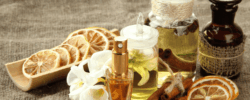Alwa luxury perfume collection with dried citrus slices, cinnamon sticks, and essential oils.