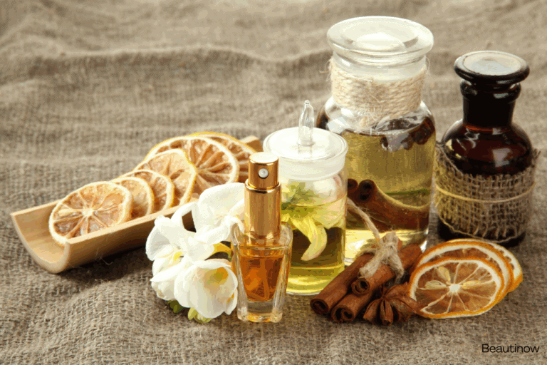 Alwa luxury perfume collection with dried citrus slices, cinnamon sticks, and essential oils.