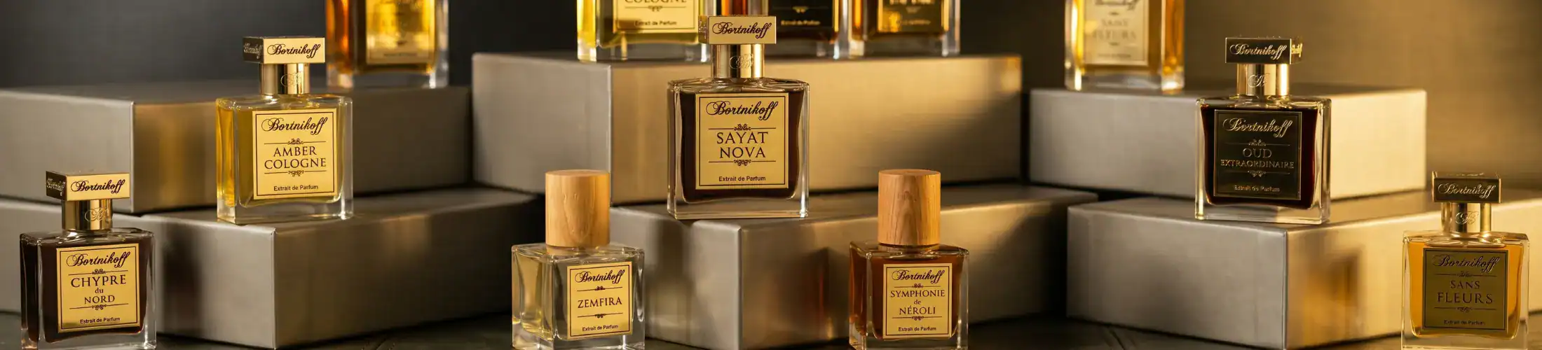 Elegant display of niche perfume bottles with gold accents and sophisticated packaging.