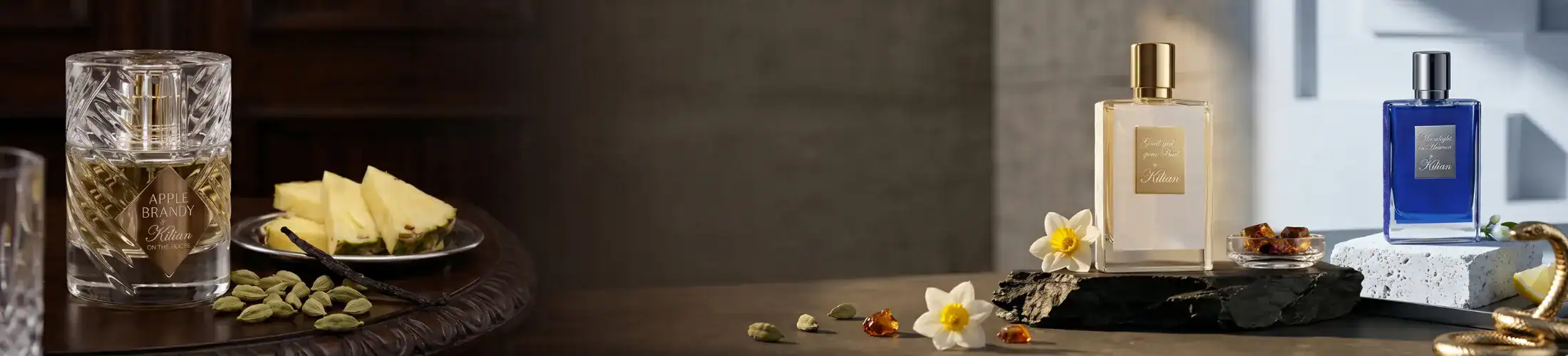 Luxury perfume bottles and skincare products arranged on a modern surface with floral decorations.