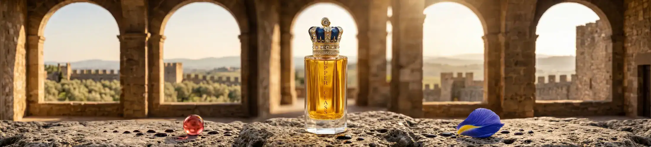 Luxury niche perfume bottle with crown cap on stone ledge, scenic historic arches at sunset.