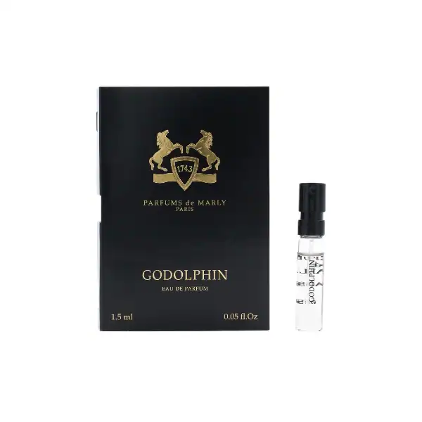 Elegant black box with gold emblem and a small perfume vial.