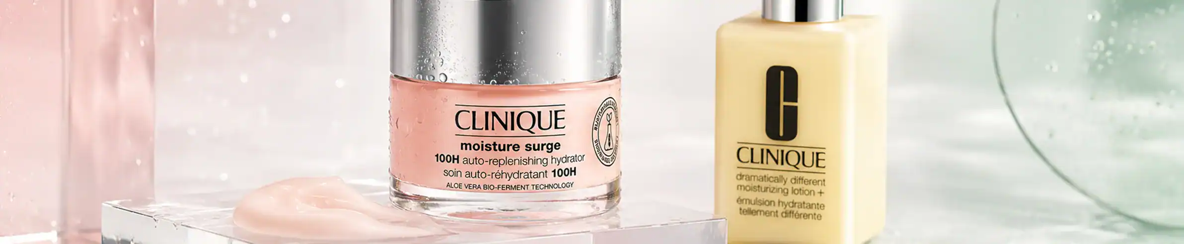 A close-up of Clinique skincare bottles, including a pink moisturizer and a yellow serum, displayed.