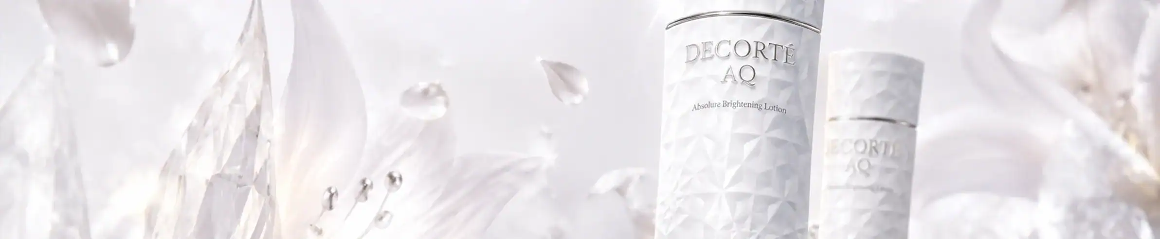 Elegant skincare bottles with white and silver accents, showcasing luxury and sophistication.