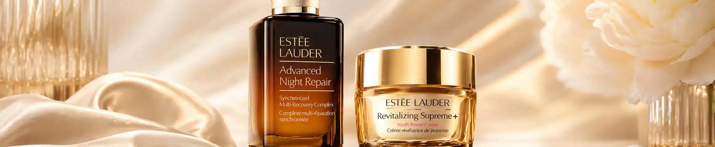 Estée Lauder Advanced Night Repair serum and Revitalizing Supreme cream displayed.