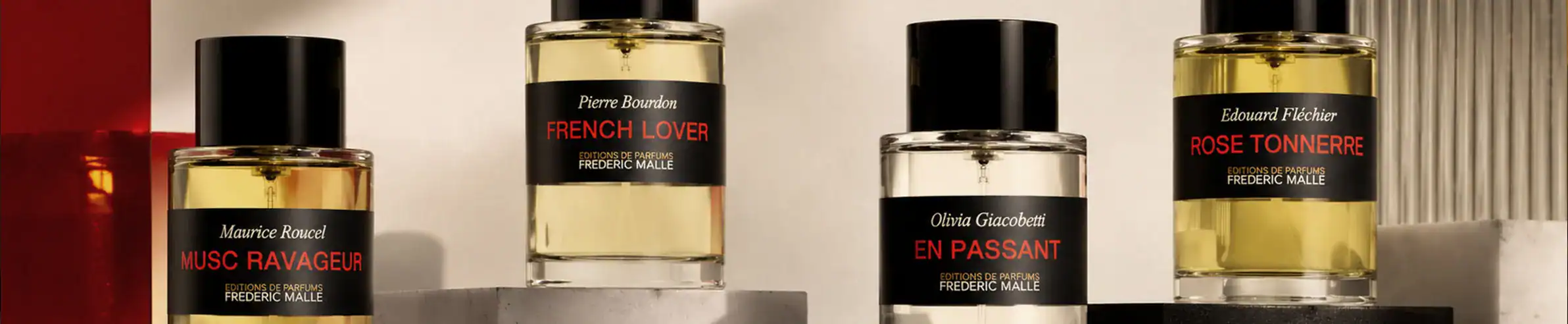 Luxurious niche perfumes by French Lover, En Passant, and Rose Tonnere showcased in elegant bottles.