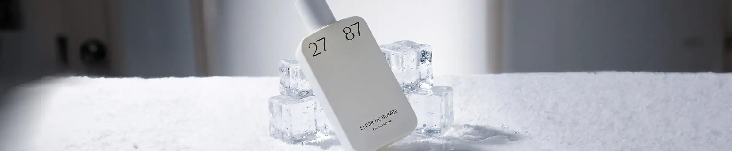 Elegant perfume bottle surrounded by ice cubes for a luxurious, refreshing presentation.