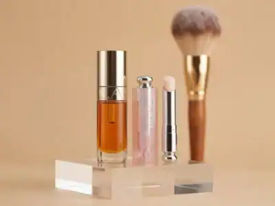 Luxury skincare and makeup products with a makeup brush on a clear stand.