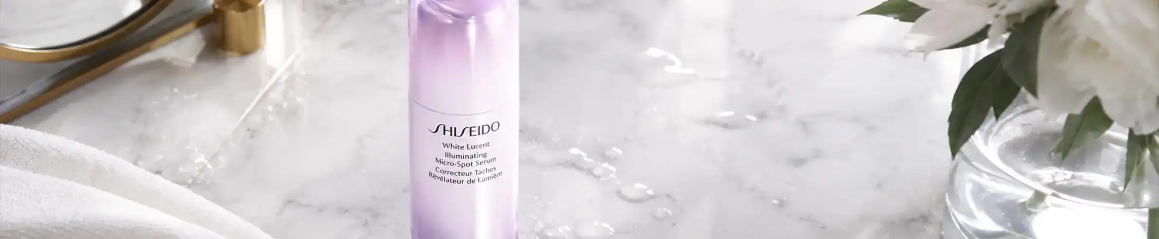 Shiseido skincare bottle - Elegant lavender-colored container with brand logo visible.