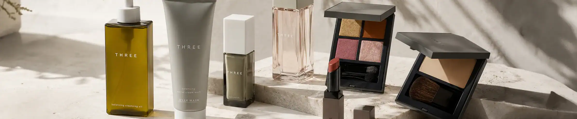 Three skincare bottles and makeup compacts from luxury brand collection at Beautinow.