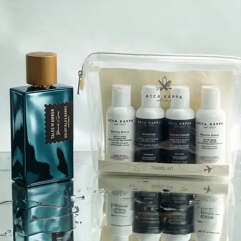 Acca Kappa travel kit with shampoo, conditioner, and body wash in white bottles.