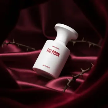 Fig Porn perfume bottle with bold red text on a luxurious satin background.
